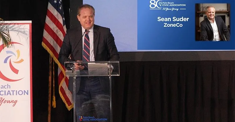 Sean Suder speaking at a conference podium